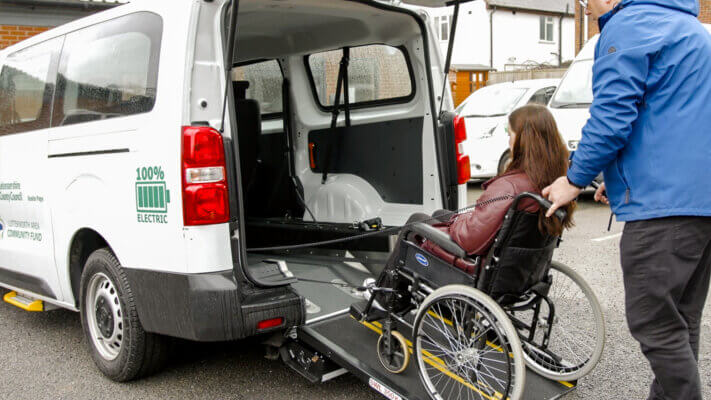 Electric vehicle with wheelchair access ramp